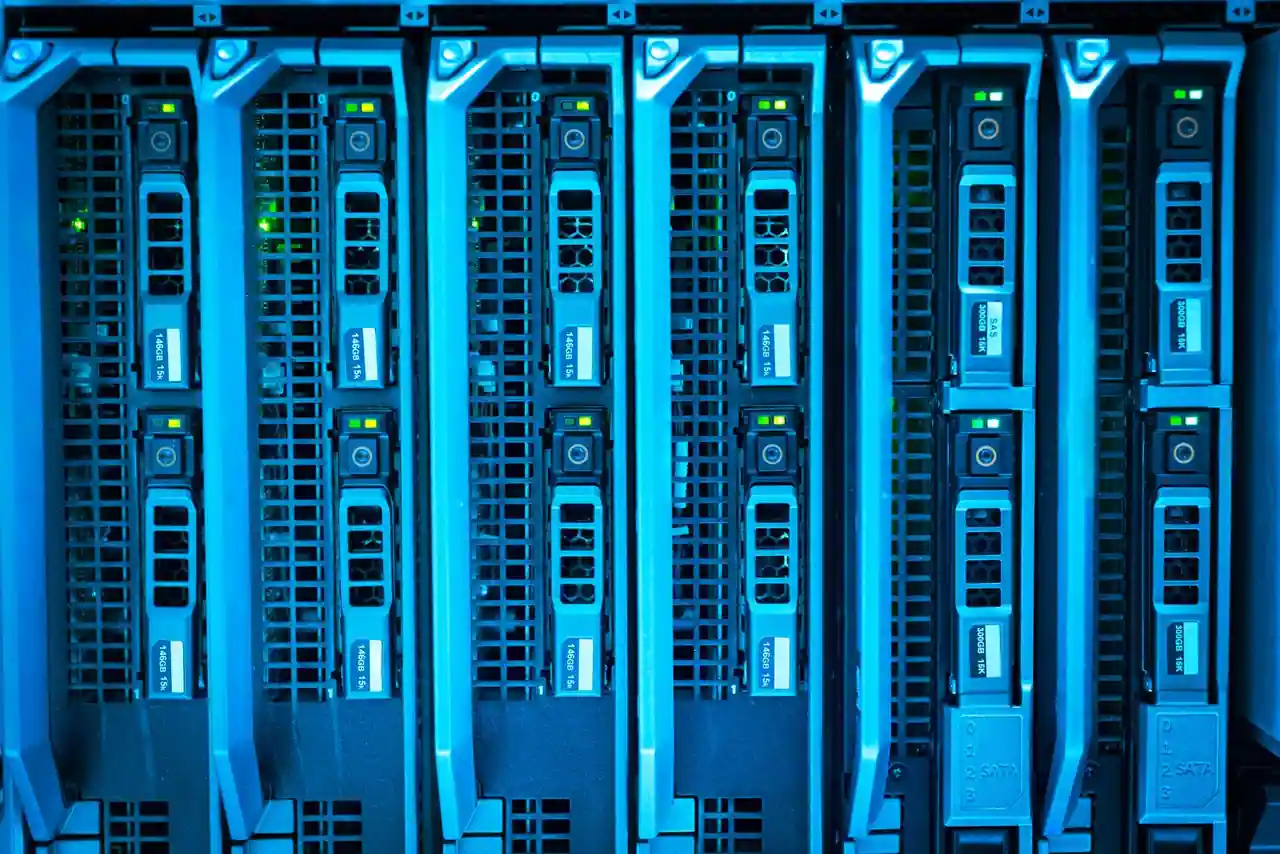 Gros plan sur des serveurs en rack éclairés de bleu, avec voyants d’état et étiquettes de disques.