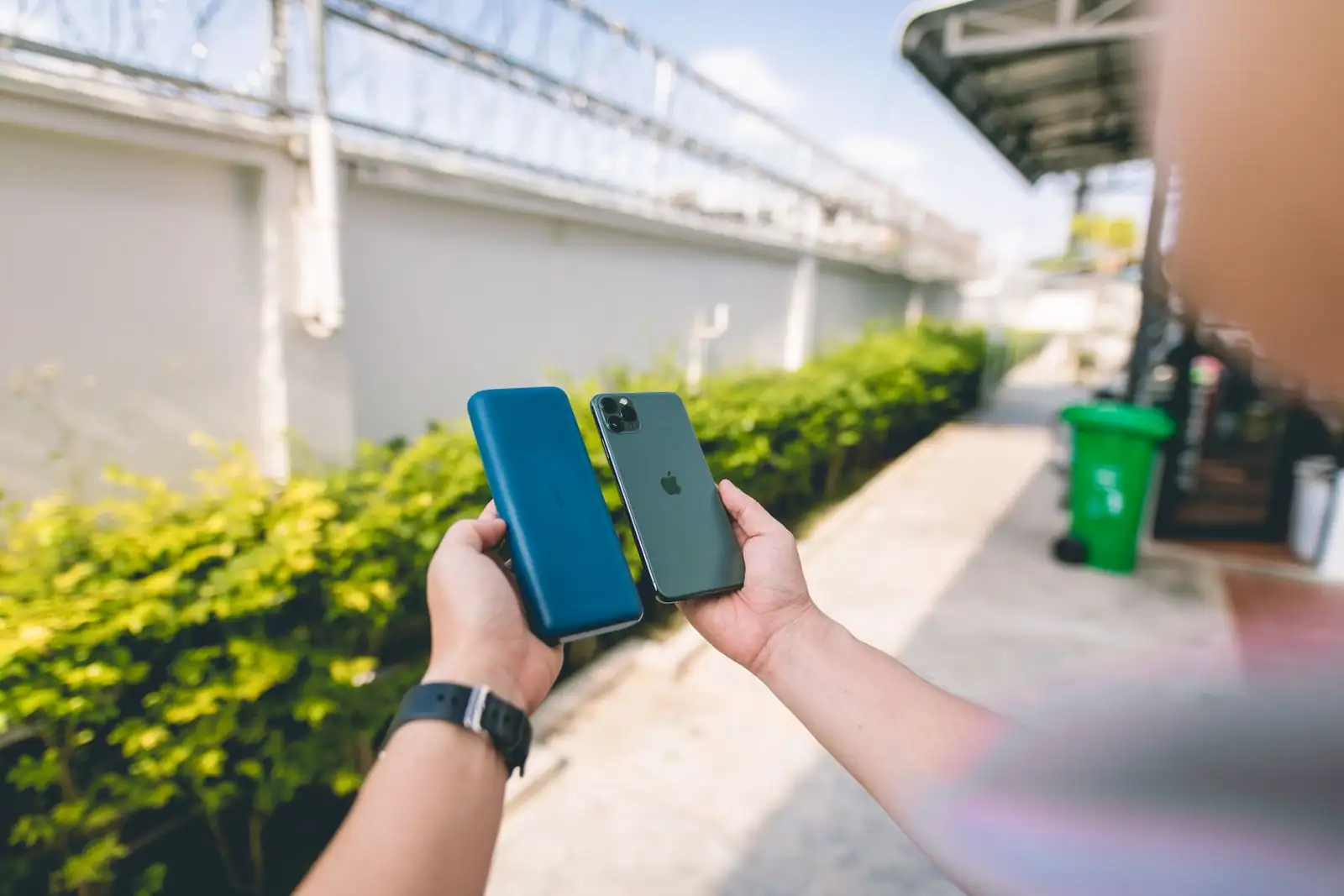 Écran d'iPhone affichant les réglages de batterie, main tenant le téléphone
